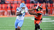 Oct 31, 2025; Syracuse, New York, USA; North Carolina Tar Heels running back Davion Gause (37) gives a stiff arm to Syracuse Orange defensive back Chris Peal (16) in the third quarter at the JMA Wireless Dome. 