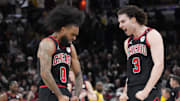 Mar 27, 2025; Chicago, Illinois, USA; Chicago Bulls guard Coby White (0) celebrates his three point basket against the Los Angeles Lakers with guard Josh Giddey (3) during the second half at United Center. Mandatory Credit: David Banks-Imagn Images