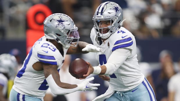 Dallas Cowboys quarterback Dak Prescott (4) hands off to running back Rico Dowdle (23) 