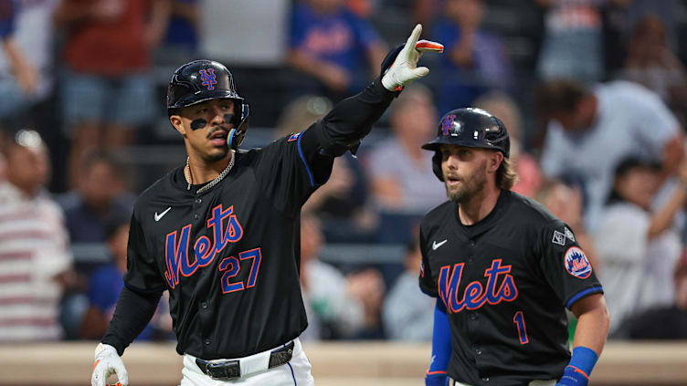 Jul 26, 2024; New York City, New York, USA; New York Mets third baseman Mark Vientos (27) celebrates his two run home run in front of second baseman Jeff McNeil (1)  during the third inning against the Atlanta Braves at Citi Field. Mandatory Credit: Vincent Carchietta-USA TODAY Sports