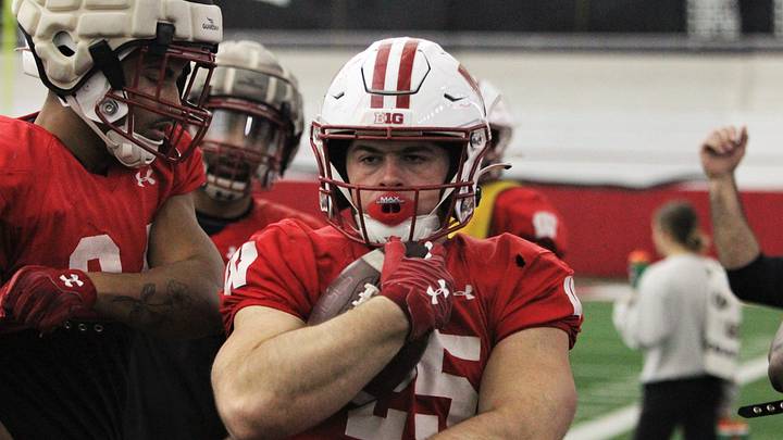 Wisconsin running back Cade Yacamelli protects the ball during a drill during practice at the McClain Center in Madison, Wisconsin on Tuesday April 23, 2024.