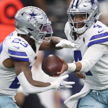 Sep 15, 2024; Arlington, Texas, USA; Dallas Cowboys quarterback Dak Prescott (4) hands off to running back Rico Dowdle (23) in the first quarter against the New Orleans Saints at AT&T Stadium. 