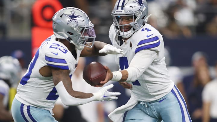 Sep 15, 2024; Arlington, Texas, USA; Dallas Cowboys quarterback Dak Prescott (4) hands off to running back Rico Dowdle (23) in the first quarter against the New Orleans Saints at AT&T Stadium. 