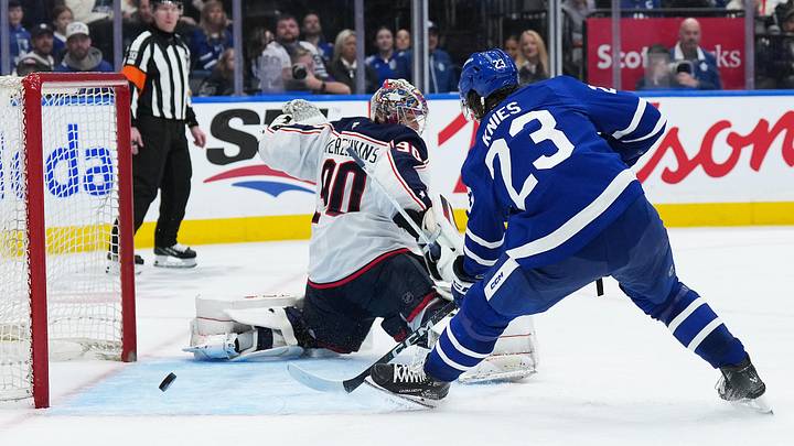 Apr 5, 2025; Toronto, Ontario, CAN; Toronto Maple Leafs left wing Matthew Knies (23) battles for the puck with Columbus Blue Jackets goaltender Elvis Merzlikins (90) during the third period at Scotiabank Arena. Mandatory Credit: Nick Turchiaro-Imagn Images