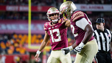 Florida State Seminoles quarterback Jordan Travis (13) pats his teammate  s helmet after the team scored a touchdown. The Florida State Seminoles defeated the Oklahoma Sooners 35-32 in the Cheez-It Bowl at Camping World Stadium on Thursday, Dec. 29, 2022.

Fsu V Oklahoma Second Half122a