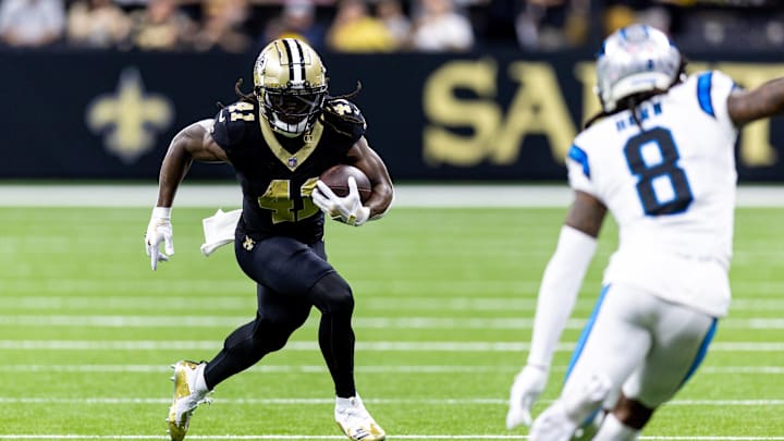 Sep 8, 2024; New Orleans, Louisiana, USA;  New Orleans Saints running back Alvin Kamara (41) runs against Carolina Panthers cornerback Jaycee Horn (8) during the first half at Caesars Superdome. Mandatory Credit: Stephen Lew-Imagn Images