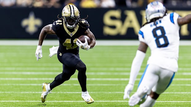 New Orleans Saints running back Alvin Kamara (41) runs against Carolina Panthers cornerback Jaycee Horn (8) 