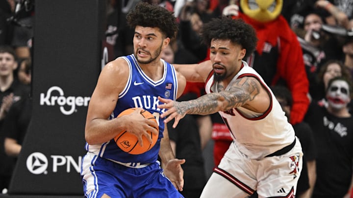 Jan 6, 2026; Louisville, Kentucky, USA;  Duke Blue Devils forward Cameron Boozer (12) posts up against Louisville Cardinals guard J'vonne Hadley (1) during the second half.