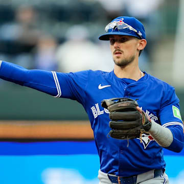 Apr 22, 2024; Kansas City, Missouri, USA; Toronto Blue Jays second base Cavan Biggio (8) throws to first base during the first inning against the Kansas City Royals at Kauffman Stadium.