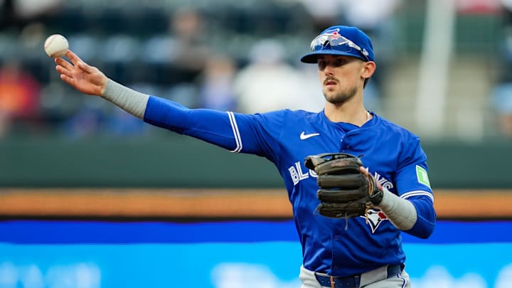 Apr 22, 2024; Kansas City, Missouri, USA; Toronto Blue Jays second base Cavan Biggio (8) throws to first base during the first inning against the Kansas City Royals at Kauffman Stadium.