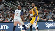 Nov 27, 2024; San Antonio, Texas, USA;  Los Angeles Lakers forward LeBron James (23) controls the ball in front of San Antonio Spurs guard Chris Paul (3) in the second half at Frost Bank Center. Mandatory Credit: Daniel Dunn-Imagn Images