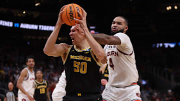 Mar 28, 2025; Atlanta, GA, USA; Michigan Wolverines center Vladislav Goldin (50) drives against Auburn Tigers forward Johni Broome (4) in the second half of a South Regional semifinal of the 2025 NCAA tournament at State Farm Arena. Mandatory Credit: Brett Davis-Imagn Images