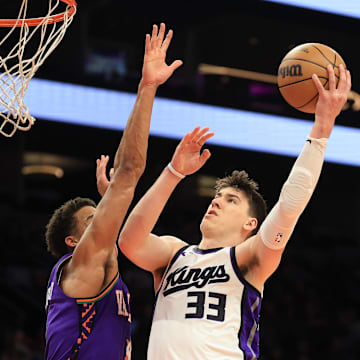Mar 14, 2025; Phoenix, Arizona, USA; Sacramento Kings forward Jake LaRavia (33) shoots the ball against the Phoenix Suns during the second half at Footprint Center. Mandatory Credit: Mark J. Rebilas-Imagn Images