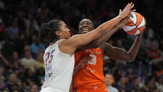 A photo of Tina Charles trying to score on Alyssa Thoma