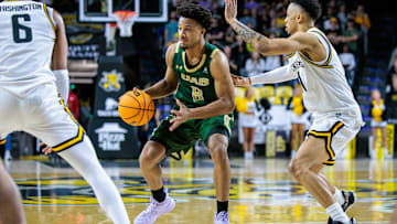 Feb 27, 2025; Wichita, Kansas, USA; UAB Blazers guard Efrem Johnson (8) sets the play around Wichita State Shockers guard Xavier Bell (1) during the first half at Charles Koch Arena. Mandatory Credit: William Purnell-Imagn Images