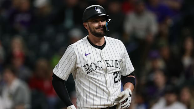 Colorado Rockies designated hitter Kris Bryant grimaces
