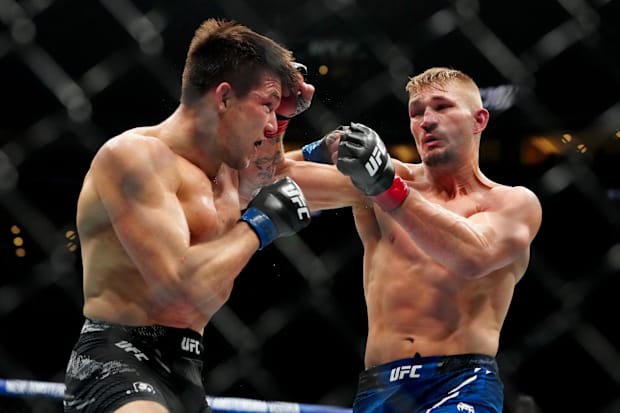 Austin Hubbard (red gloves) fights Alexander Hernandez (blue gloves) during UFC 307 at Delta Center. 