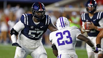 Aug 31, 2024; Oxford, Mississippi, USA; Mississippi Rebels offensive linemen Micah Pettus (57) blocks Furman Paladins linebacker Dylan Chiedo (23) during the first half at Vaught-Hemingway Stadium. Mandatory Credit: Petre Thomas-Imagn Images