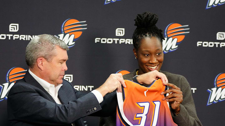 Feb 10, 2022; Phoenix, Arizona, USA; Phoenix Mercury general manager Jim Pitman (left) and Tina Charles hold up her jersey during Charles introductory press conference at Footprint Center. Mandatory Credit: Patrick Breen-The Republic Feb 10, 2022; Phoenix, Arizona, USA; Phoenix Mercury general manager Jim Pitman (left) and Tina Charles hold up her jersey during Charles introductory press conference at Footprint Center. Mandatory Credit: Patrick Breen-The Republic
