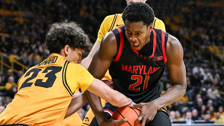 Dec 6, 2025; Iowa City, Iowa, USA; Iowa Hawkeyes guard Isaia Howard (23) and Maryland Terrapins forward Pharrel Payne (21) battle for the ball during the first half at Carver-Hawkeye Arena. Mandatory Credit: Jeffrey Becker-Imagn Images