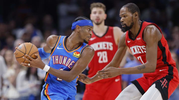 Thunder guard Shai Gilgeous-Alexander drives toward Rockets forward Kevin Durant during the NBA season opener. Thunder guard Shai Gilgeous-Alexander drives toward Rockets forward Kevin Durant during the NBA season opener.