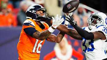 Dec 15, 2024; Denver, Colorado, USA; Indianapolis Colts cornerback Samuel Womack III (33) breaks up a pass intended for Denver Broncos wide receiver Troy Franklin (16) in the fourth quarter at Empower Field at Mile High. Mandatory Credit: Ron Chenoy-Imagn Images