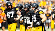 Aug 9, 2025; Iowa offensive linemen Gennings Dunker (67) Kade Pieper (58) and Logan Jones (65) run a drill during the Hawkeyes Kids Day NCAA football open practice at Kinnick Stadium in Iowa City, Iowa. Mandatory Credit: Joseph Cress for the Des Moines Register