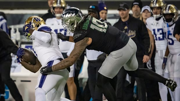 Oregon outside linebacker Matayo Uiagalelei brings down Washington running back Jonah Coleman as the No. 1 Oregon Ducks host 