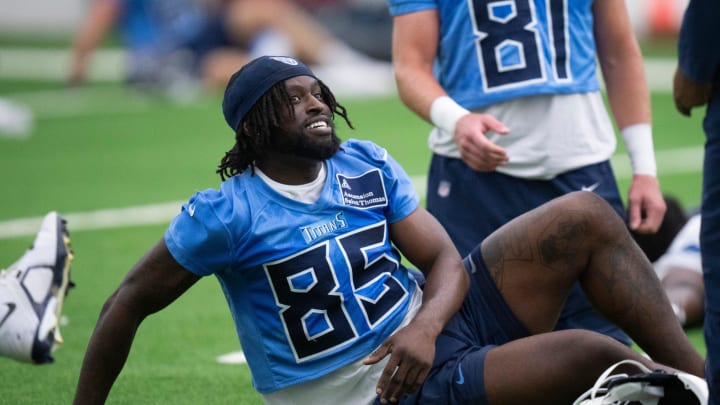 Tight end Chig Okonkwo (85) talks with a coach during the Tennessee Titans mandatory mini-camp at Ascension Saint Thomas Sports Park in Nashville, Tenn., Tuesday, June 4, 2024.