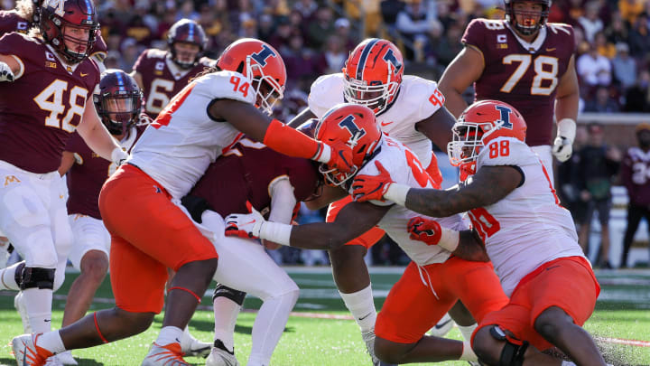 Nov 6, 2021; Minneapolis, Minnesota, USA; Minnesota Golden Gophers quarterback Tanner Morgan (2) is brought down by Illinois Fighting Illini defensive lineman Jer'Zhan Newton (94) and linebacker Isaiah Gay (92) for a loss in the fourth quarter at Huntington Bank Stadium. Mandatory Credit: Matt Krohn-USA TODAY Sports