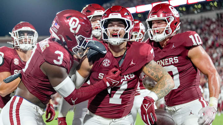 Oklahoma linebacker Jaren Kanak (7) scoops up a fumbled punt return and runs the ball for a touchdown and is celebrated by his teammates in the second half of an NCAA football game between Oklahoma (OU) and Temple at the Gaylord Family Oklahoma Memorial Stadium in Norman, Okla., on Friday, Aug. 30, 2024.