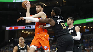 Mar 16, 2024; Memphis, Tennessee, USA; Oklahoma City Thunder forward Chet Holmgren (7) passes the ball
as Memphis Grizzlies forward-center Jaren Jackson Jr. (13) defends during the first half at FedExForum. Mandatory Credit: Petre Thomas-Imagn Images