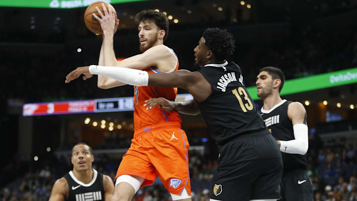 Mar 16, 2024; Memphis, Tennessee, USA; Oklahoma City Thunder forward Chet Holmgren (7) passes the ball
as Memphis Grizzlies forward-center Jaren Jackson Jr. (13) defends during the first half at FedExForum. Mandatory Credit: Petre Thomas-Imagn Images