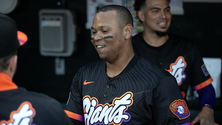 San Francisco Giants designated hitter Rafael Devers greets his new teammates in the dugout. San Francisco Giants designated hitter Rafael Devers greets his new teammates in the dugout.