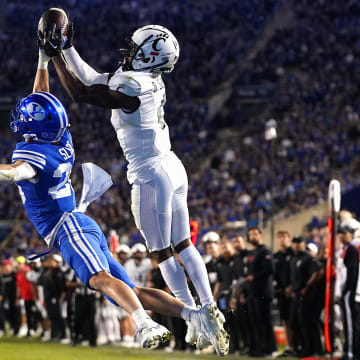 Cincinnati Bearcats linebacker Dorian Jones (6) catches a touchdown pass as Brigham Young Cougars safety Ethan Slade (26) defends in the fourth quarter during a college football game between the Brigham Young Cougars and the Cincinnati Bearcats, Saturday, Sept. 30, 2023, at LaVell Edwards Stadium in Provo, Utah.