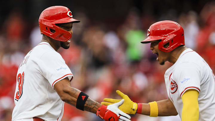 Cincinnati Reds outfielder Will Benson (30) high fives designated hitter Noelvi Marte (16)