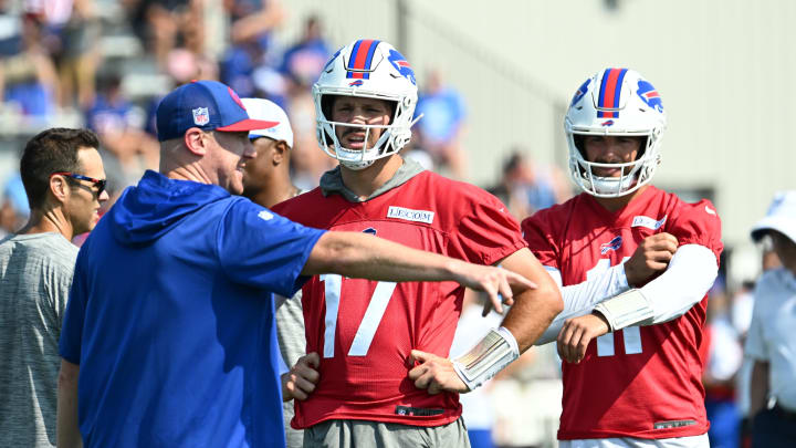 Jul 24, 2024; Rochester, NY, USA;  Buffalo Bills quarterback Josh Allen (17) and quarterback Mitchell Trubisky (11) listen to instruction from offensive coordinator Jor Brady during training camp at St. John Fisher University. 