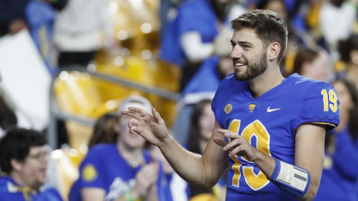 Nov 16, 2023; Pittsburgh, Pennsylvania, USA; Pittsburgh Panthers quarterback Nate Yarnell (19) leads the Pitt band in the playing of the school fight song after defeating the Boston College Eagles at Acrisure Stadium. Pittsburgh won 24-16. Mandatory Credit: Charles LeClaire-USA TODAY Sports