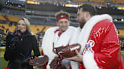 Kansas City Chiefs quarterback Patrick Mahomes (middle) and tight end Travis Kelce (right) open their Netflix Christmas GameDay cake after the Chiefs defeated the Pittsburgh Steelers at Acrisure Stadium. 