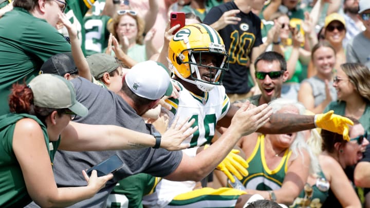 Green Bay Packers wide reciever Malik Heath (18) does a Lambeau Leap after scoring against the Baltimore Ravens.