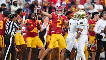 Nov 30, 2024; Los Angeles, California, USA; Southern California Trojans wide receiver Duce Robinson (2) catches a pass against Notre Dame Fighting Irish safety Rod Heard II (2) during the second half at the Los Angeles Memorial Coliseum. Mandatory Credit: Gary A. Vasquez-Imagn Images