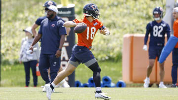 Caleb Williams steps and fires during passing drills at Bears offseason work.