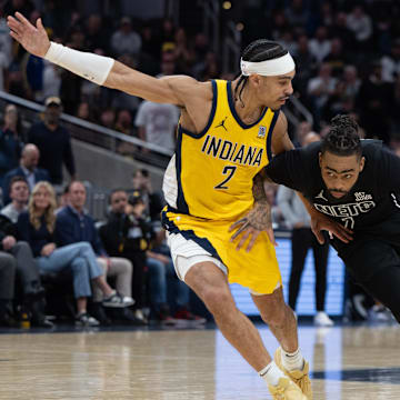 Mar 20, 2025; Indianapolis, Indiana, USA: Brooklyn Nets guard D'Angelo Russell (1) dribbles the ball while Indiana Pacers guard Andrew Nembhard (2) defends in the second half at Gainbridge Fieldhouse. Mandatory Credit: Trevor Ruszkowski-Imagn Images