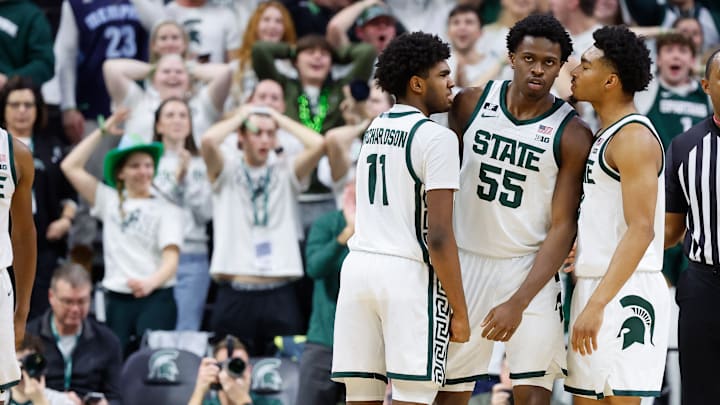 Coen Carr #55 of the Michigan State Spartans celebrates with his teammates Jase Richardson #11 of the Michigan State Spartans and Jaden Akins #3 of the Michigan State Spartans after a dunk late in the second half against the Minnesota Golden Gophers at Breslin Center on January 28, 2025 in East Lansing, Michigan.
