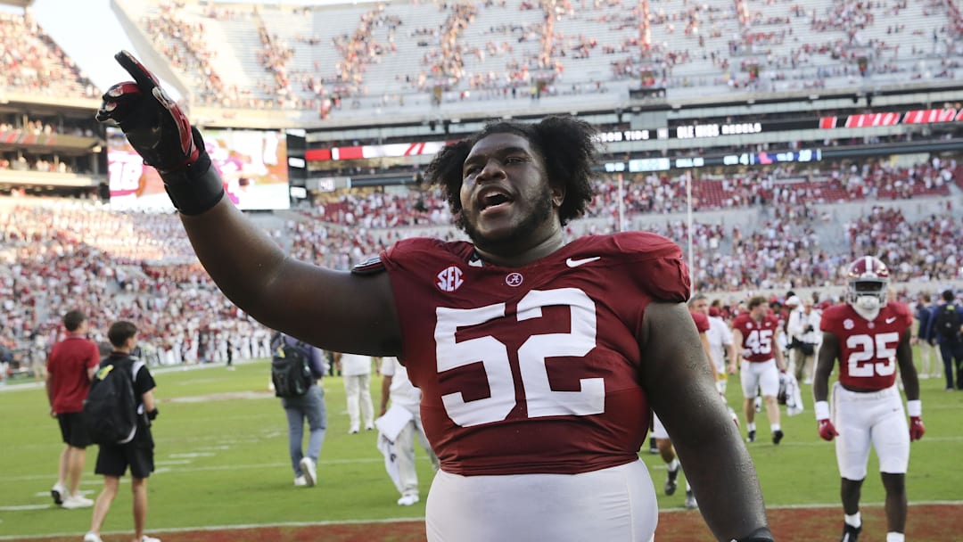 Sep 23, 2023; Tuscaloosa, Alabama, USA;  Alabama Crimson Tide offensive lineman Tyler Booker (52) celebrates as he leaves the field at Bryant-Denny Stadium. Alabama defeated Mississippi 24-10. Mandatory Credit: Gary Cosby Jr.-Imagn Images