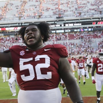 Sep 23, 2023; Tuscaloosa, Alabama, USA;  Alabama Crimson Tide offensive lineman Tyler Booker (52) celebrates as he leaves the field at Bryant-Denny Stadium. Alabama defeated Mississippi 24-10. Mandatory Credit: Gary Cosby Jr.-USA TODAY Sports