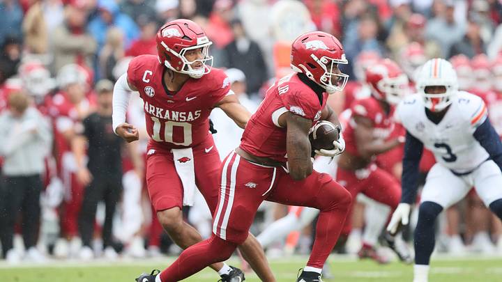 Oct 25, 2025; Fayetteville, Arkansas, USA; Arkansas Razorbacks quarterback Taylen Green (10) hands off to running back Mike Washington Jr (4) during the first quarter against the Auburn Tigers at Donald W. Reynolds Razorback Stadium. Mandatory Credit: Nelson Chenault-Imagn Images