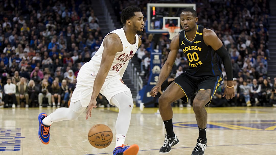 Dec 30, 2024; San Francisco, California, USA; Cleveland Cavaliers guard Donovan Mitchell (45) drives past Golden State Warriors forward Jonathan Kuminga (00) during the fourth quarter at Chase Center. Mandatory Credit: John Hefti-Imagn Images Dec 30, 2024; San Francisco, California, USA; Cleveland Cavaliers guard Donovan Mitchell (45) drives past Golden State Warriors forward Jonathan Kuminga (00) during the fourth quarter at Chase Center. Mandatory Credit: John Hefti-Imagn Images