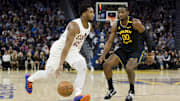 Dec 30, 2024; San Francisco, California, USA; Cleveland Cavaliers guard Donovan Mitchell (45) drives past Golden State Warriors forward Jonathan Kuminga (00) during the fourth quarter at Chase Center. Mandatory Credit: John Hefti-Imagn Images