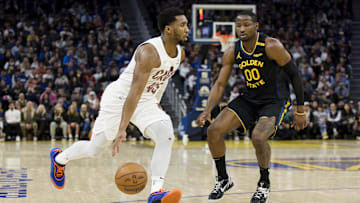 Dec 30, 2024; San Francisco, California, USA; Cleveland Cavaliers guard Donovan Mitchell (45) drives past Golden State Warriors forward Jonathan Kuminga (00) during the fourth quarter at Chase Center. Mandatory Credit: John Hefti-Imagn Images